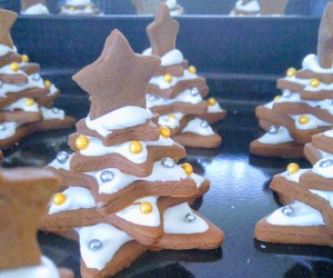 A few complete Gingerbread Christmas trees decorated with icing and sprinkles