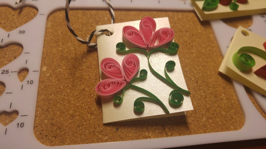 A handmade quilled gift tag - two pink roses