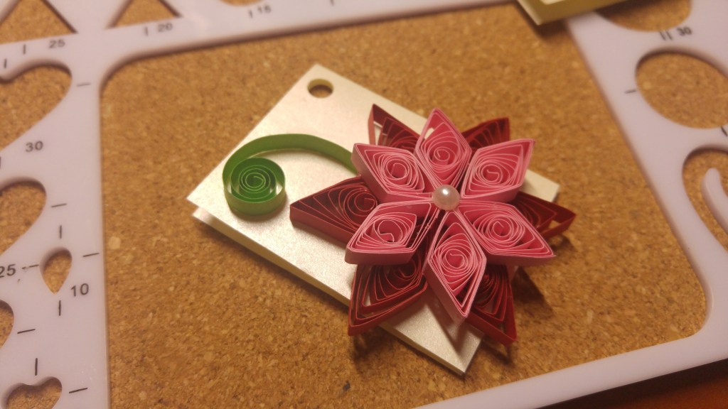 A handmade quilled gift tag -