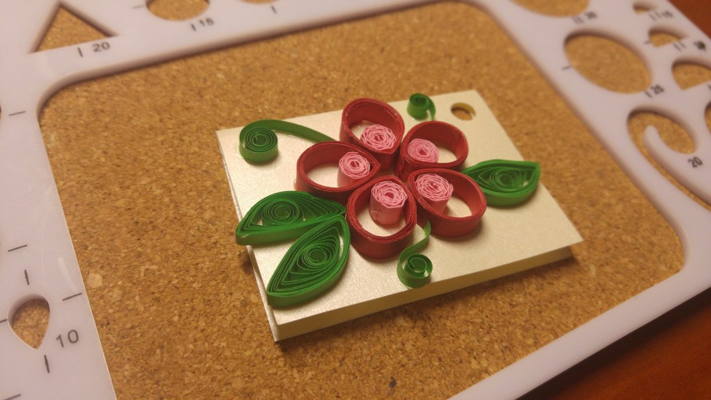 A handmade gift tag - red and pink flower with round petals