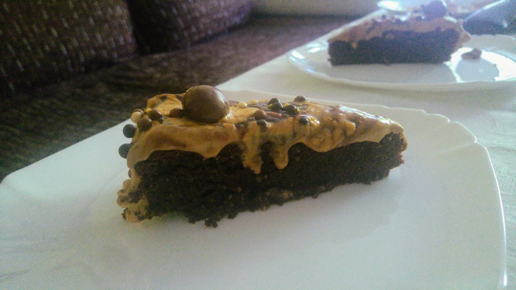 A slice of Nutella cake with coffee cream on a white plate