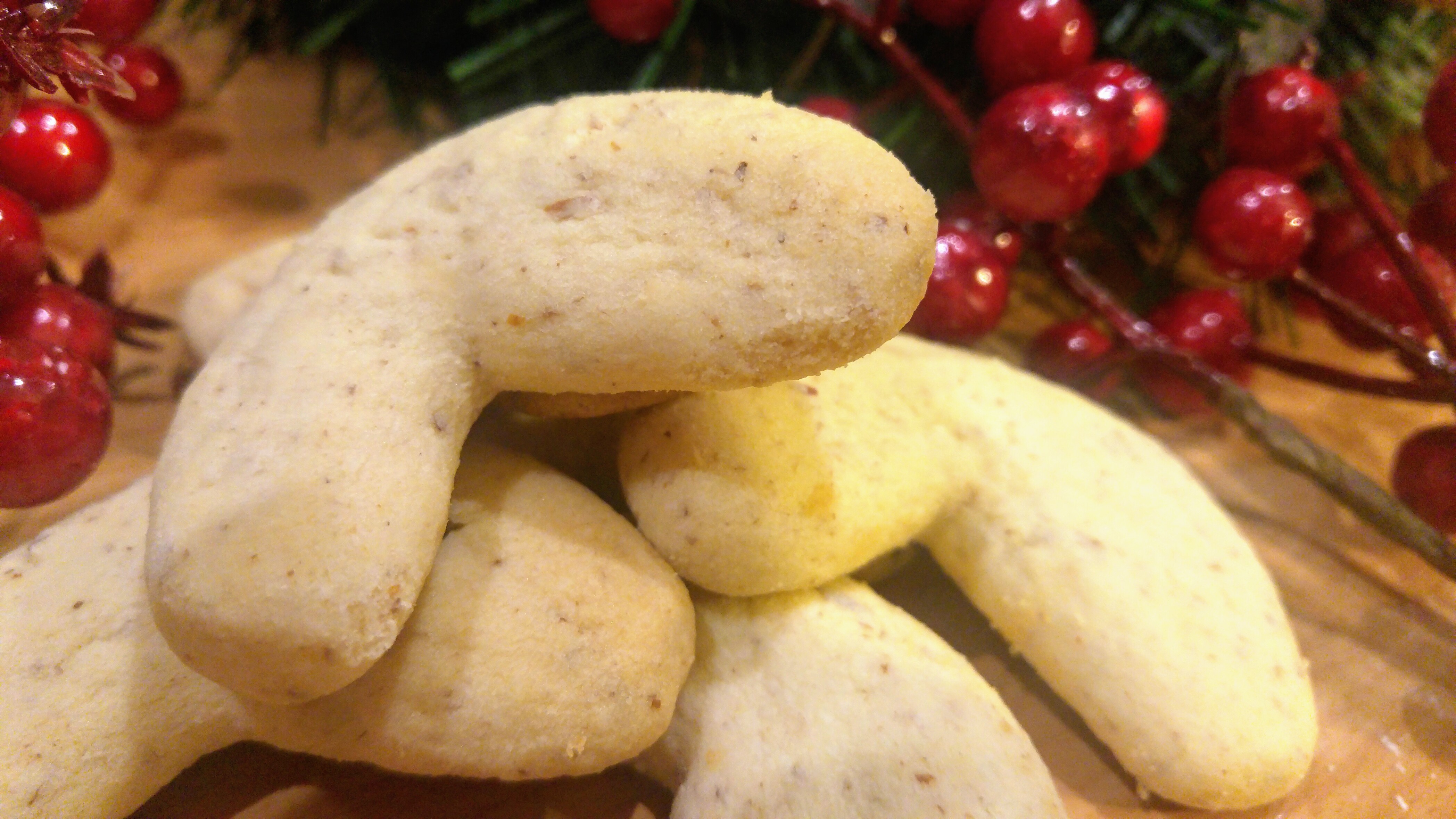 A pile of baked almond crescent cookies