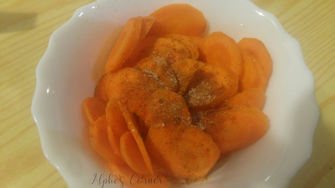 Sliced carrot in a bowl, with seasoning