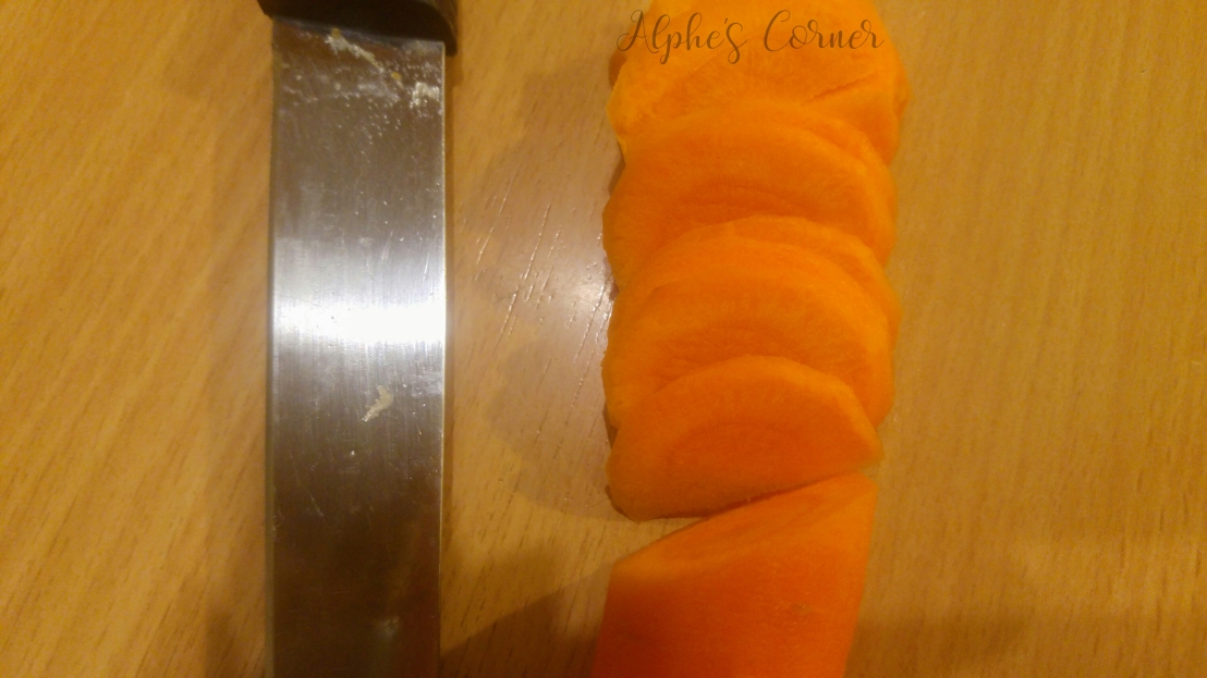 Sliced carrot next to a knife