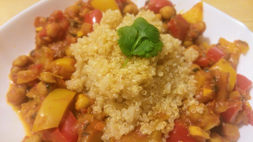 Chickpea, tomato and bell pepper curry served with quinoa, garnished with rice