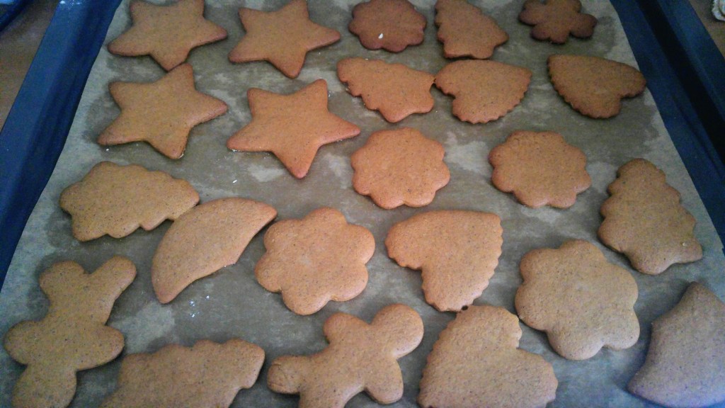 Baked gingerbread cut out cookies on a baking tray