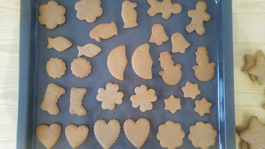 Baked gingerbread Christmas cookies on a baking tray