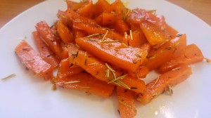 Honey glazed carrots with rosemary on a white plate