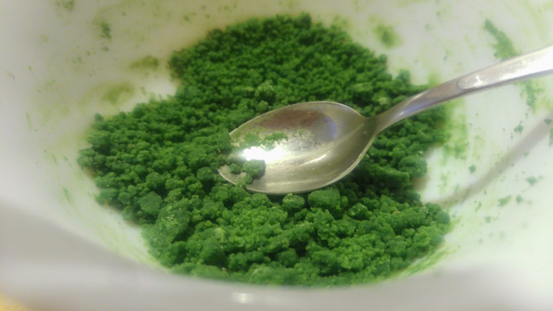 Green chocolate dust in a bowl