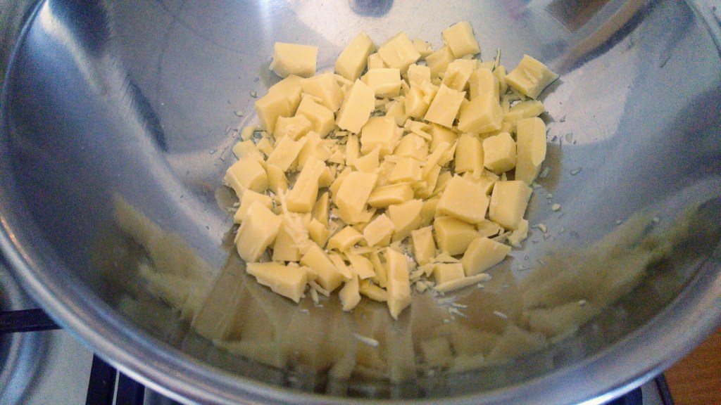 Chopped up white chocolate in a metal bowl