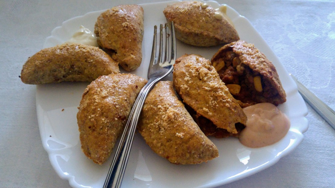 Oven baked dumplings with dips, on a plate