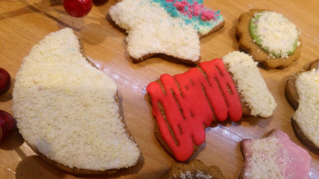 Cookies decorated with coloured royal icing and ground almonds