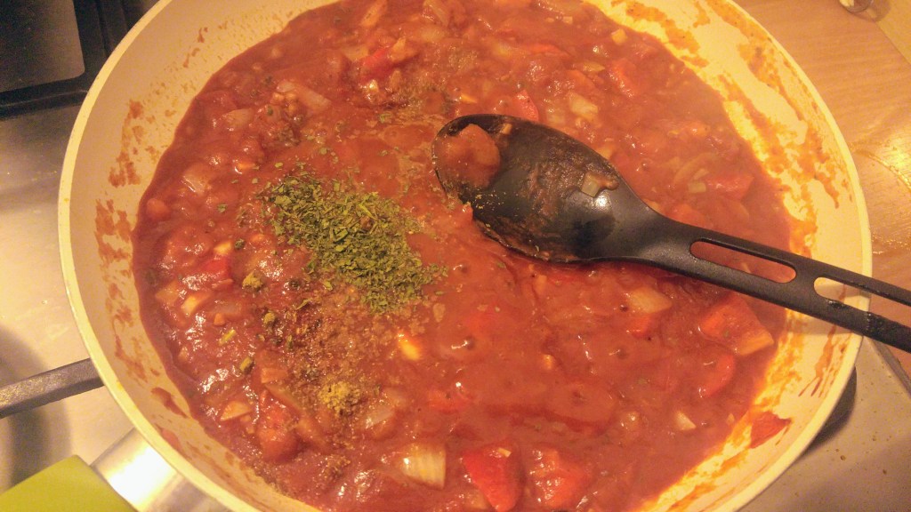 Shakshuka - tomatoes and onions on a frying pan