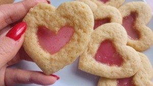 Holding pink stained glass heart sugar cookies
