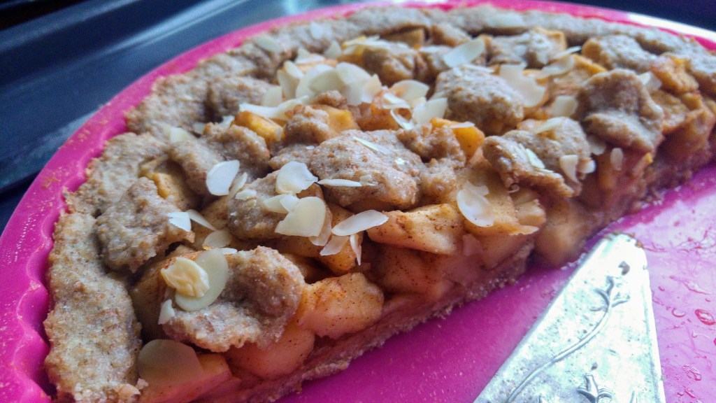 Wholemeal apple tart in a pink tray