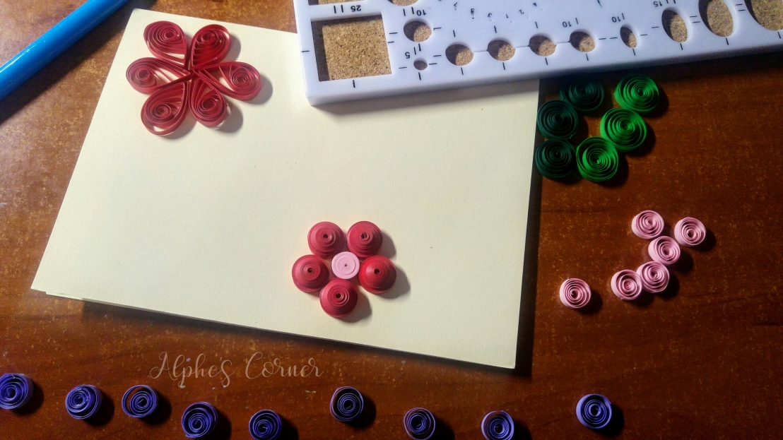 Quilling flowers, purple petals and the base card