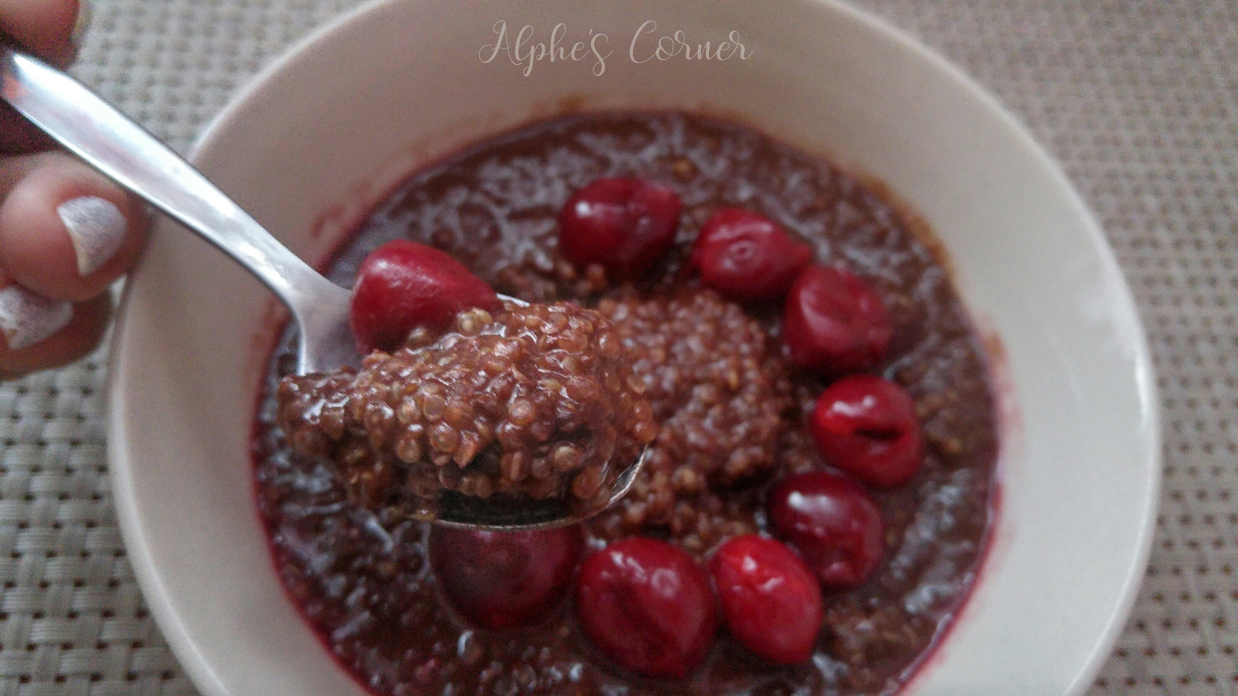 Chocolate breakfast quinoa in a bowl with a spoon