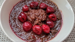Chocolate breakfast quinoa with cherries in a bowl
