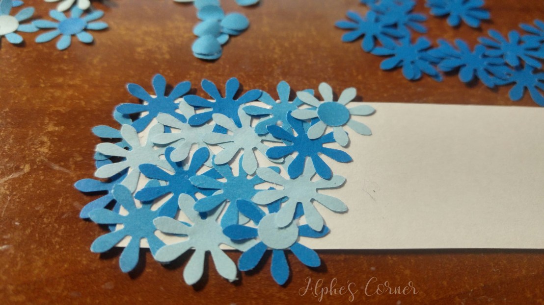 Simple DIY flower bookmarks - beginning to glue the flowers to the bookmark