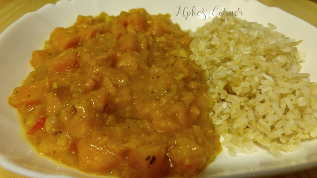 Spicy sweet potato stew on a plate, with rice