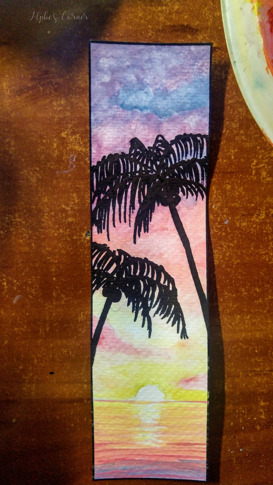 A watercolour bookmark - sunset, palm trees and the sea - completed