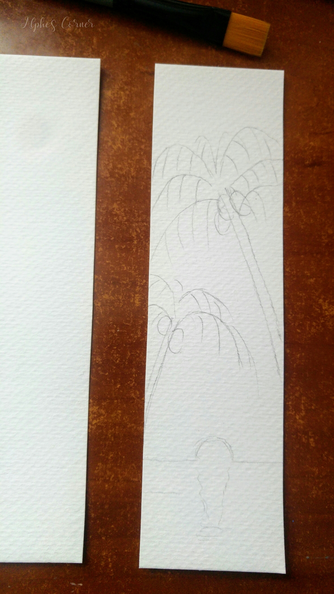 Sketching the sunset and palm trees on a bookmark