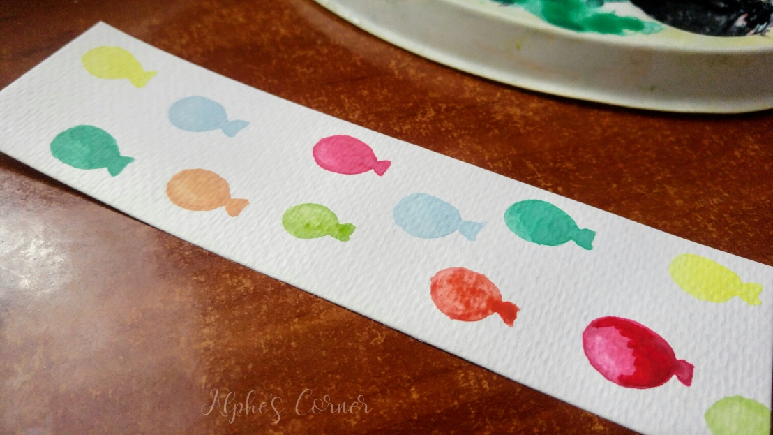 Painting watercolour balloons on a bookmark