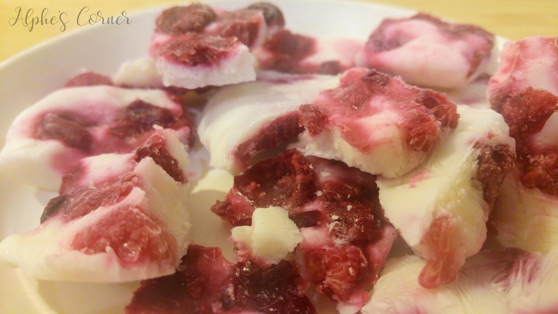 Frozen yoghurt bark broken into pieces on a plate