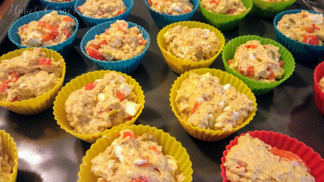 Raw feta, olives and bell pepper muffins in the moulds