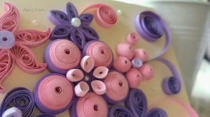 Close up on a pink and purple quilled paper flower