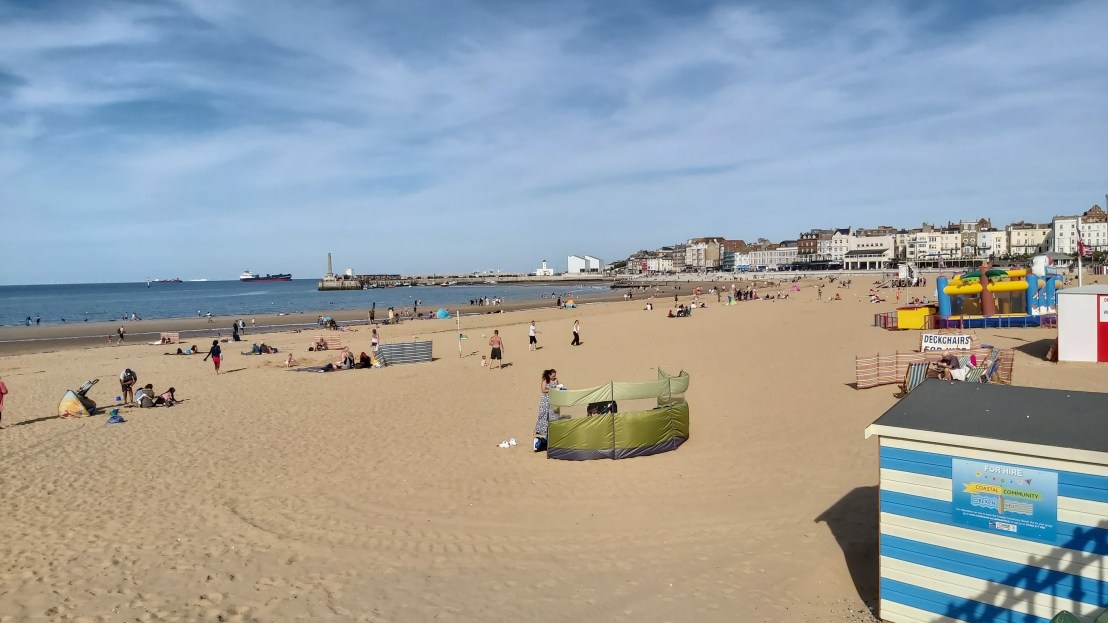 The sandy beach in Margate, people sunbathing
