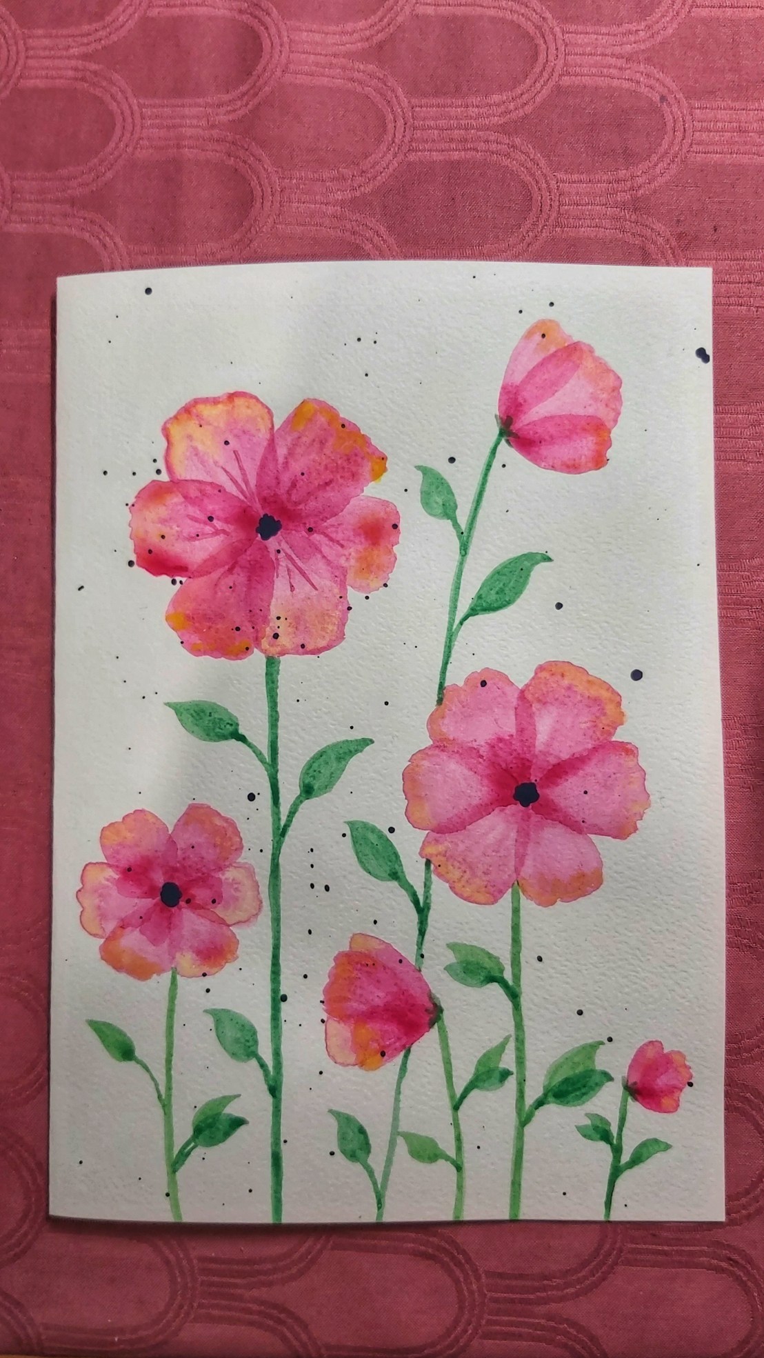 A completed birthday card with neon pink watercolour poppies