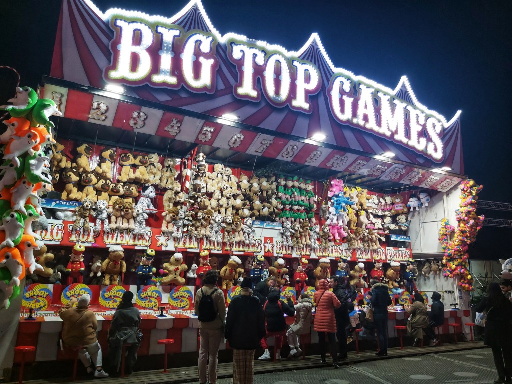 A game stand with hundreds of plush toys to be won.