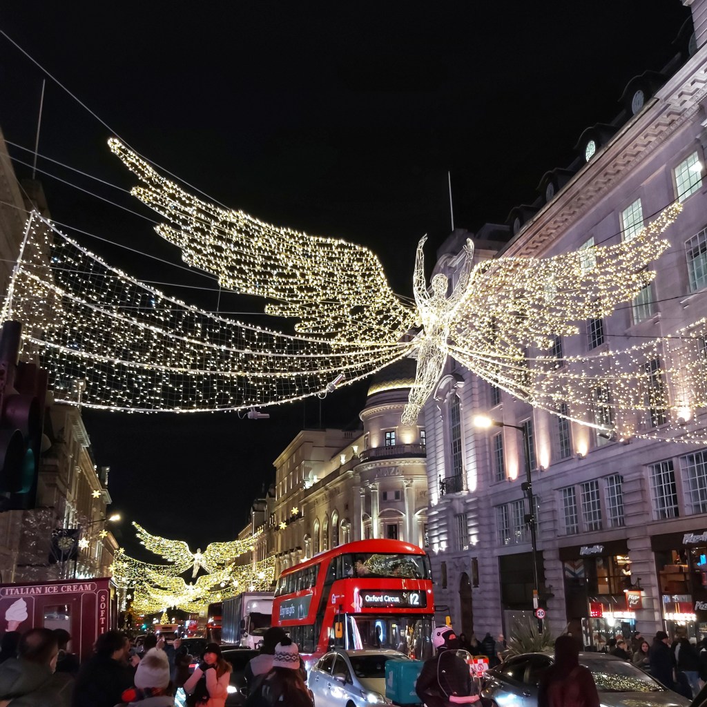 Giant angels made of fairy lights over Regent's Street, London.