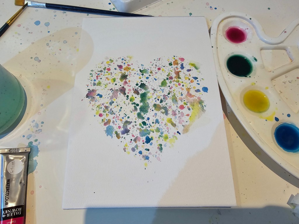 Handmade Valentine's Day Card. Heart made of colourful splashes of watercolour paints.