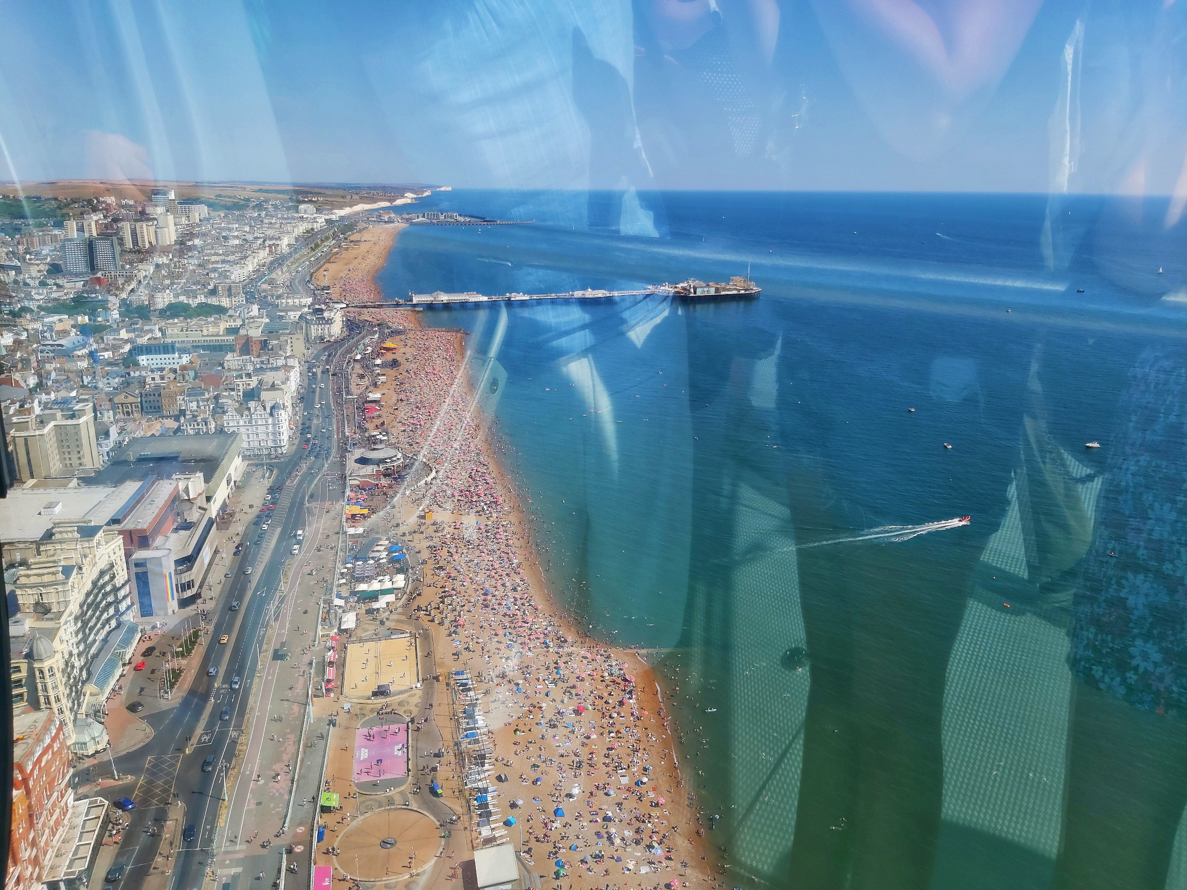 View from Brighton i360 viewing platform. Photo taken on a sunny day. You can see the sea and the beach.