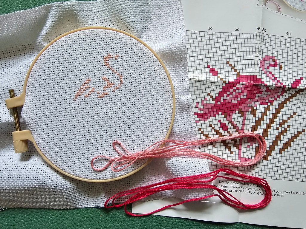 DIY Cross Stitch - Flamingo. The first block of colour - the lightest pink - is completed.
