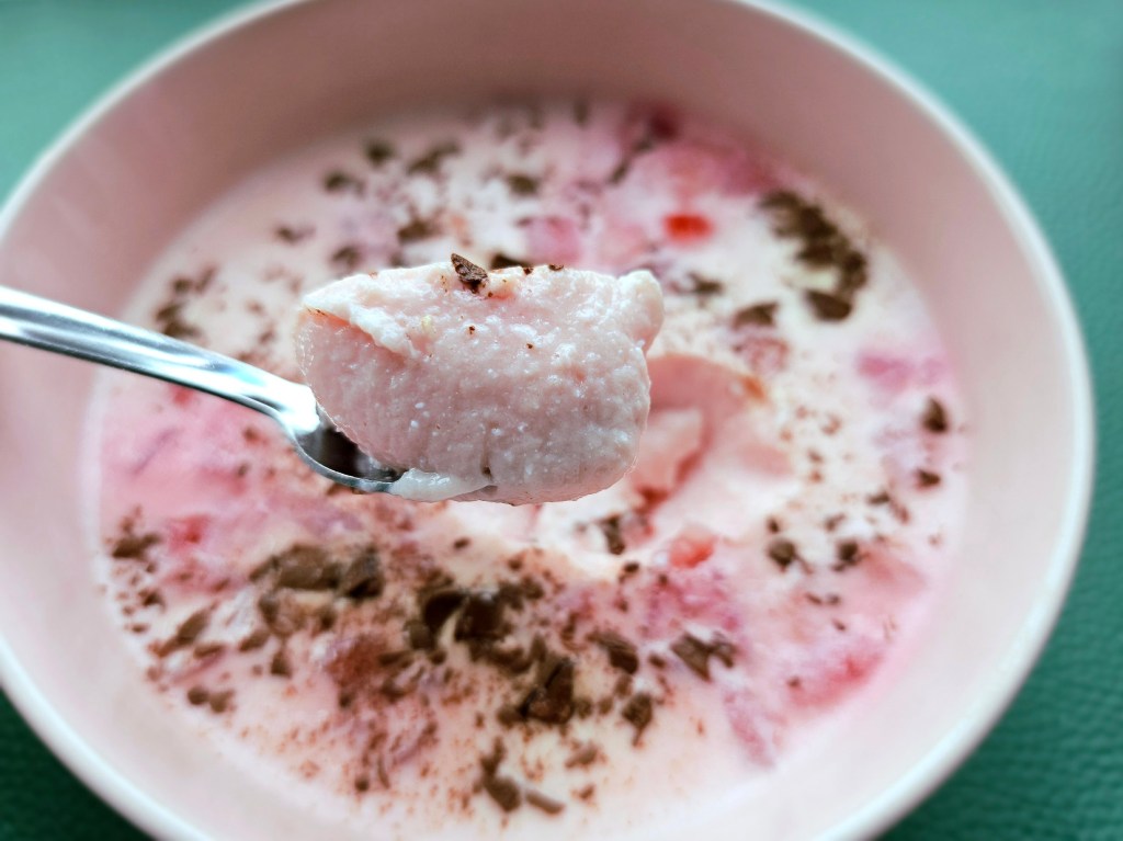 A spoonful of high protein strawberry dessert. You can see the jelly-like texture.