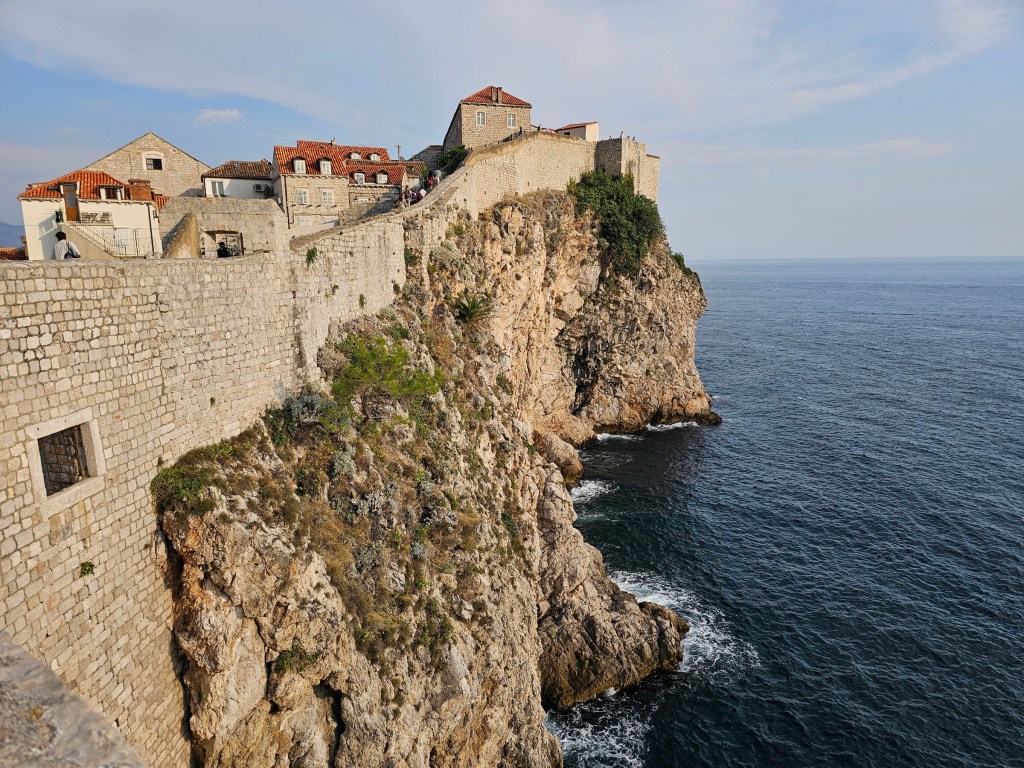 Dubrovnik Old Town City Walls viewed from the outside, where they meet the Adriatic Sea