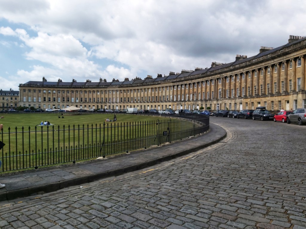 Characteristic terraced houses in a crescent layout in Bath, England.