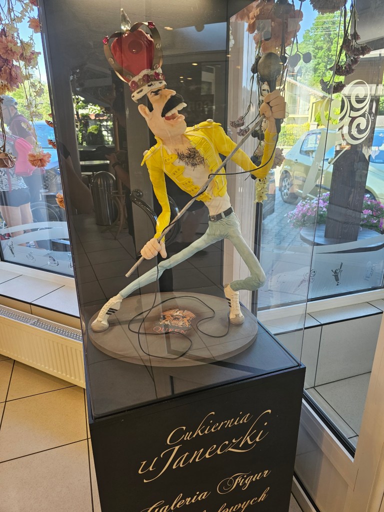 A sculpture made of coloured chocolate depicting Freddie Mercury wearing a yellow jacket.