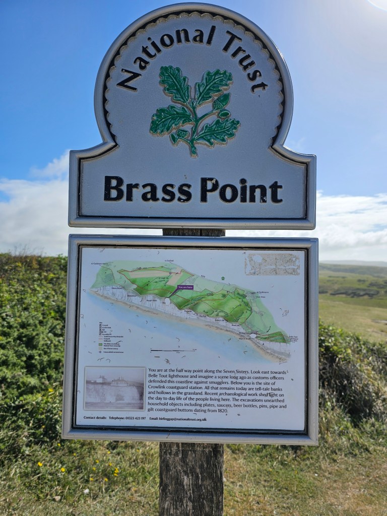 A National Trust sign on top of the middle cliff out of the Seven Sisters - Brass Point. The sign includes a map of the Seven Sisters.