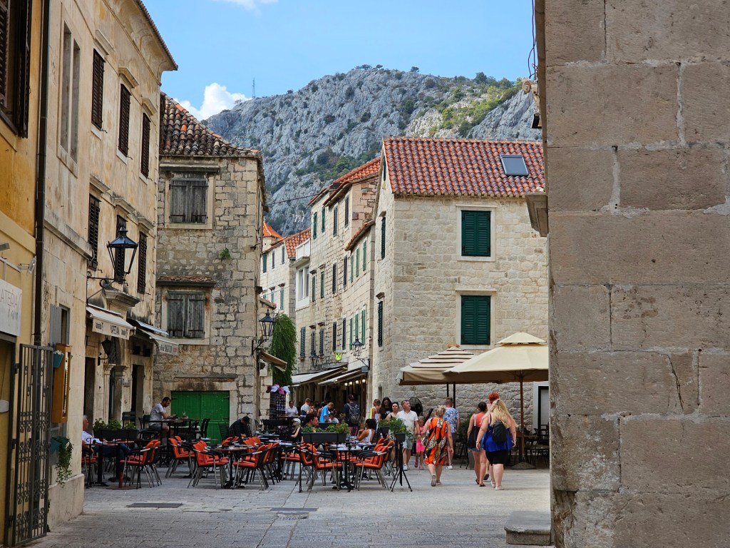 Limestone houses with green window shutters in the Old Town in Omiš, Croatia.