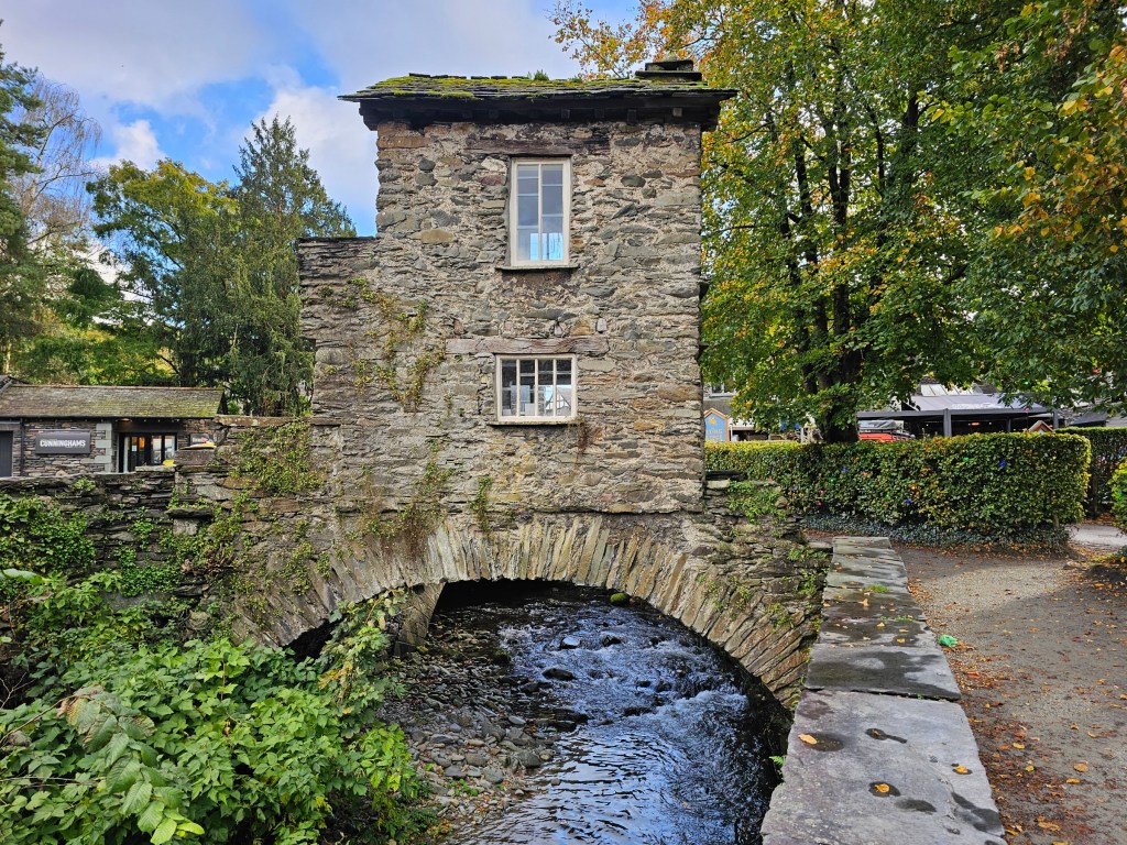 A small stone bridge house in Ambleside, England.