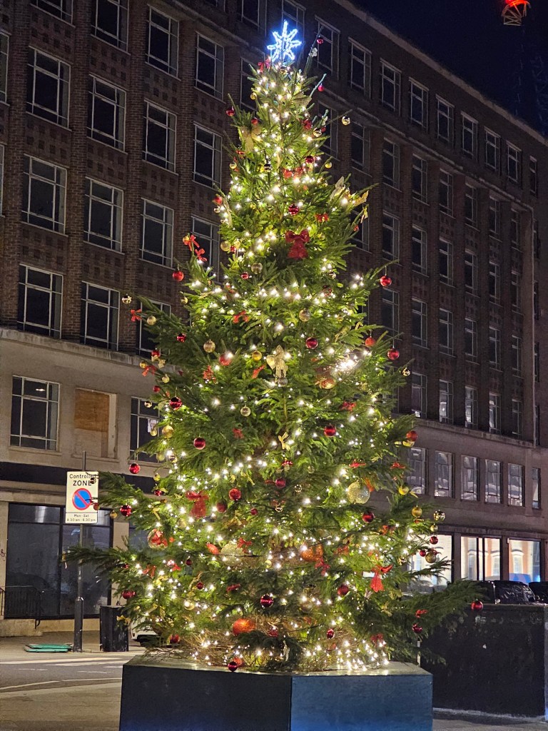 A classic Christmas tree with fairy lights and red baubles at Hanover Square, London.