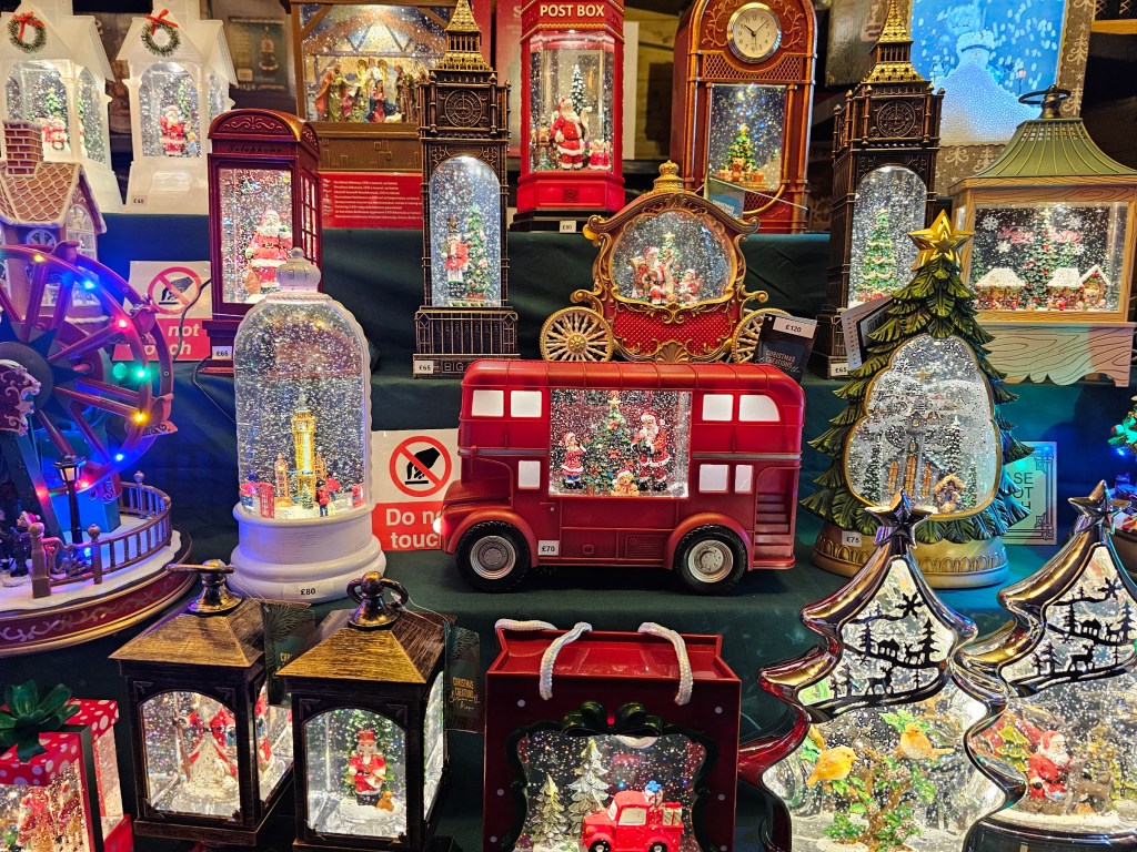 Moving Christmas decorations at one of the vendor stalls at Winter by the River Christmas market in London.