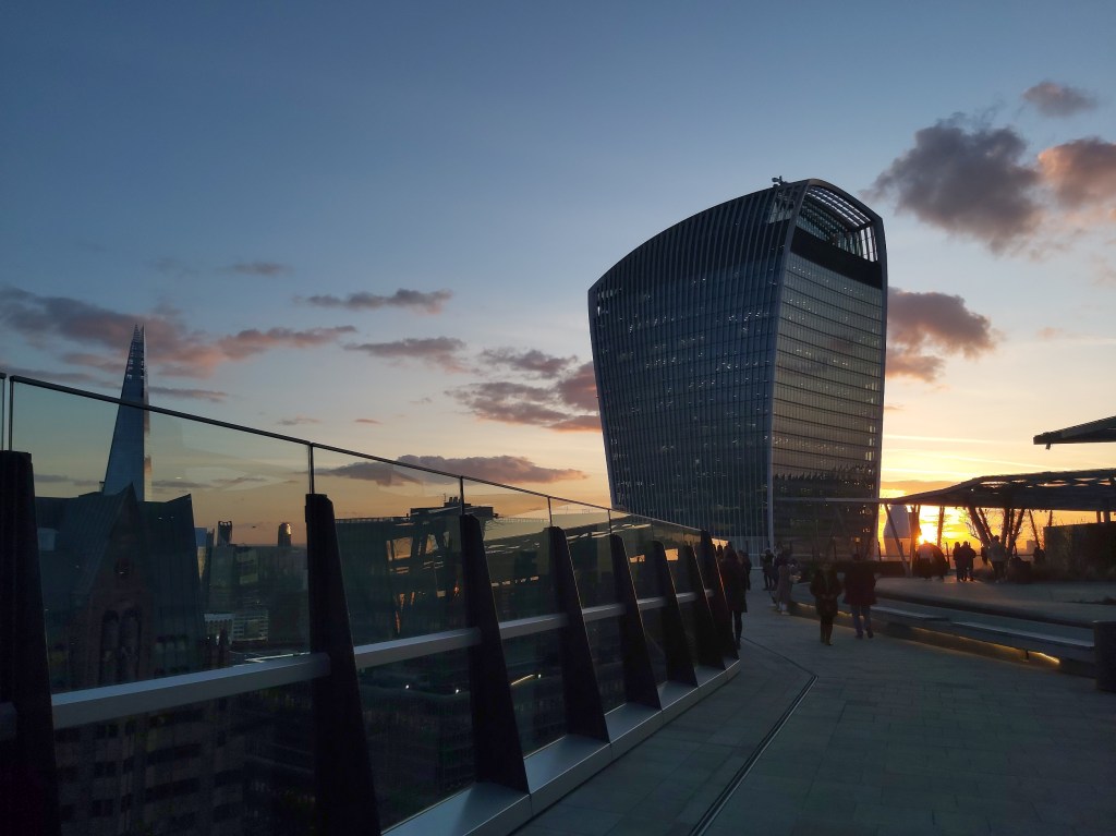 A view from Garden at 120, a free viewing platform in London, at sunset. You can see the walkie talkie building and the Shard