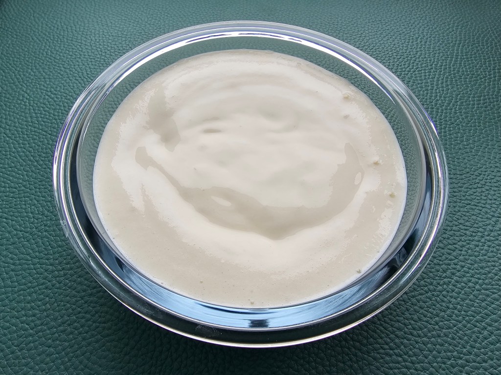 Batter for high protein cheesecake souffle, in a small ovenproof dish.