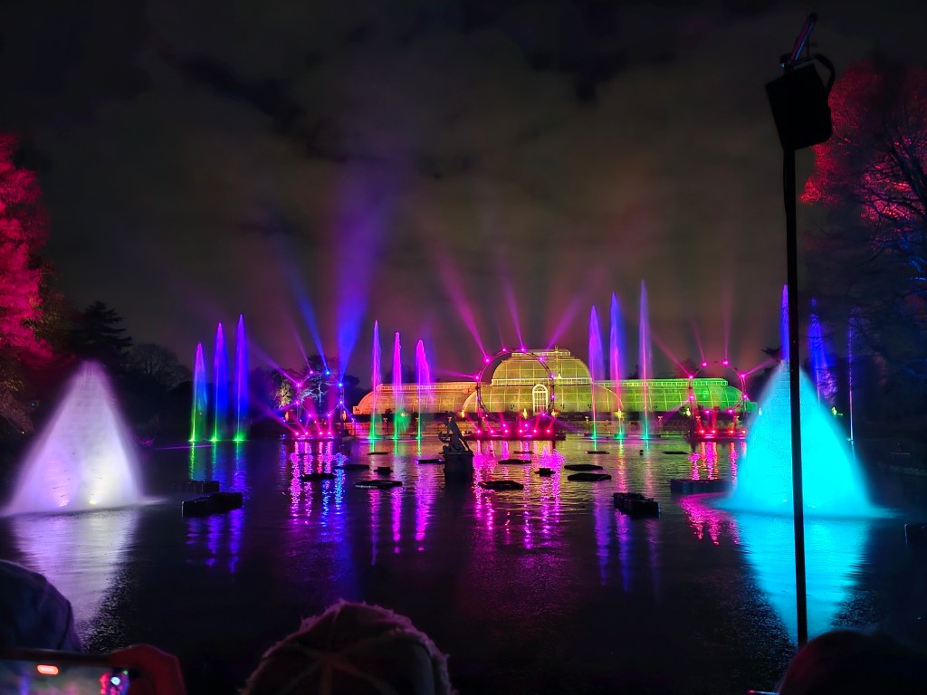 Water and lights show in front of a palm house at Kew Gardens, London, during Christmas.