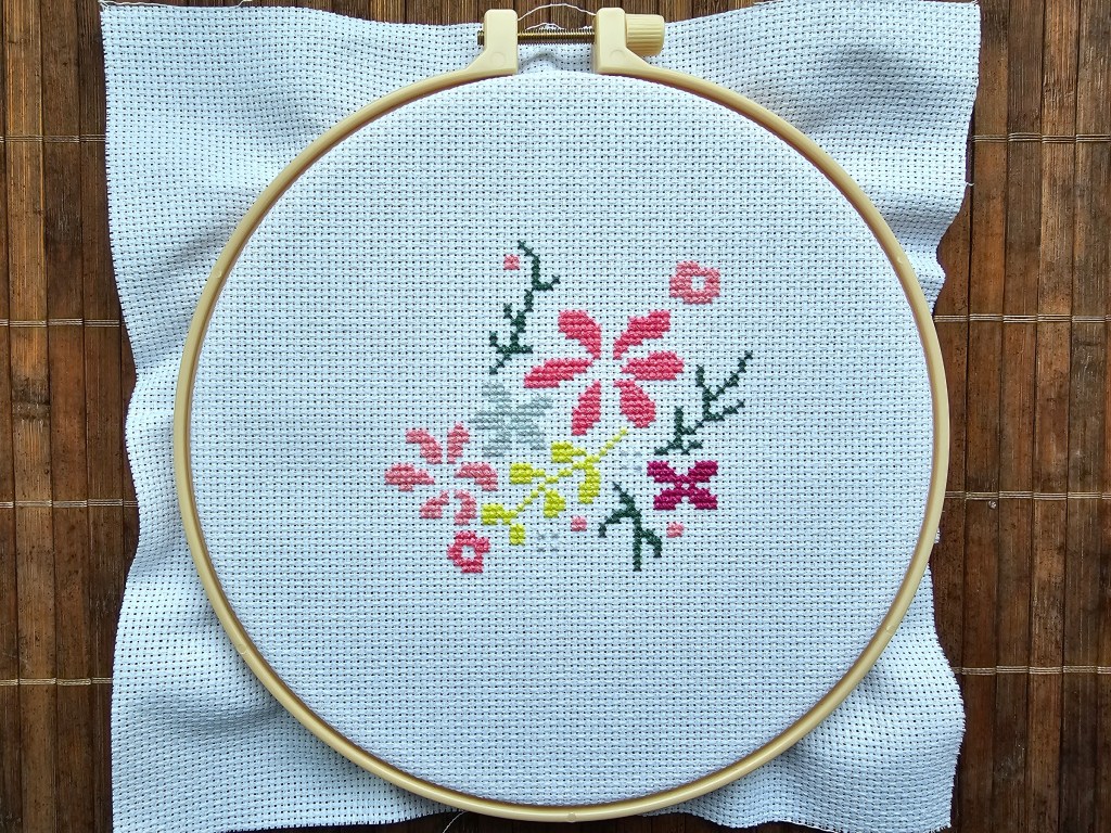 The first few elements of a floral heart cross stitch design.